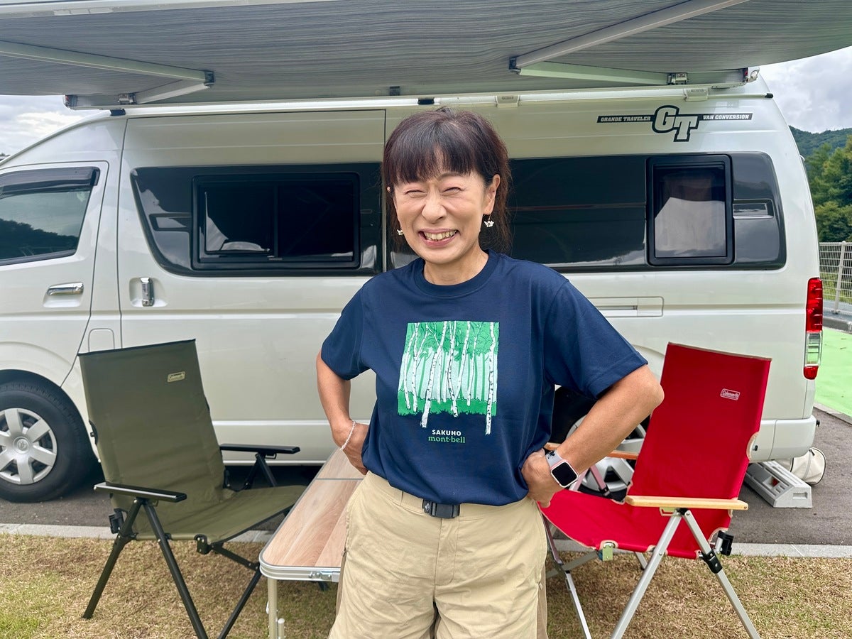 紺色のTシャツを着てポーズをとる女性