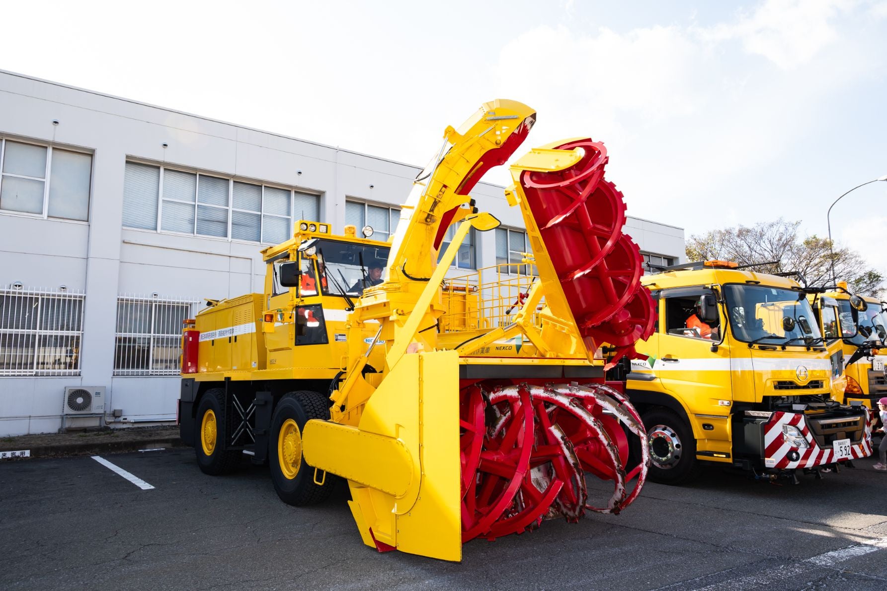 積雪を削り取り、シューターから遠くへ吹き飛ばすためのオーガと回転刃を備えたロータリー除雪車。