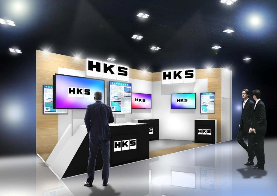 HKSの展示会ブースのCG完成イメージ。ブラックとホワイトを基調としたブースに複数のディスプレイが並ぶ