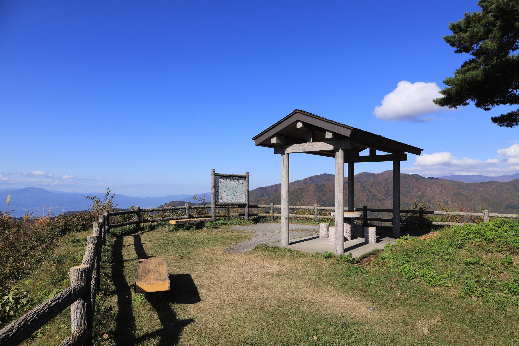 ALT 道中にひっそりと佇む、木の温もりあふれるあずまやが整備された展望パーキング。どこまでも幾重にも重なる、奥信濃の山稜をのんびりと見渡すことができる休憩スポットだ