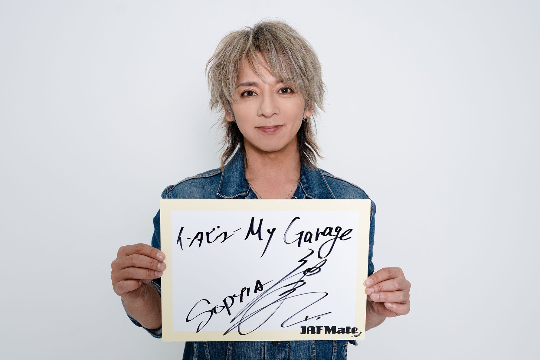 サインを持つ松岡さん
