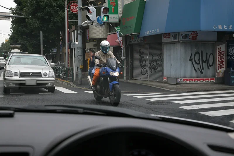 対向車の陰からすり抜ける直進の原付